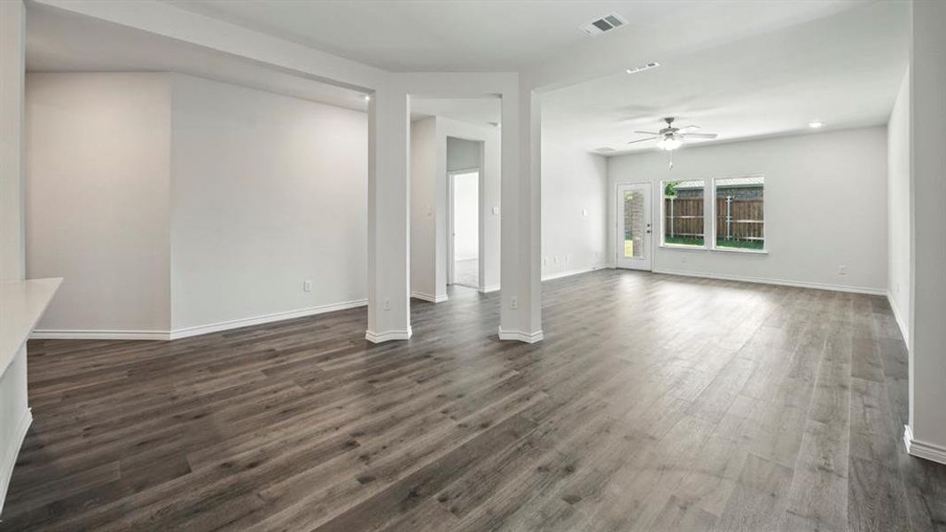 Unfurnished living room with ceiling fan, dark wood-style flooring, and recessed lighting Unfurnished living room with ceiling fan, dark wood-style flooring, and recessed lighting