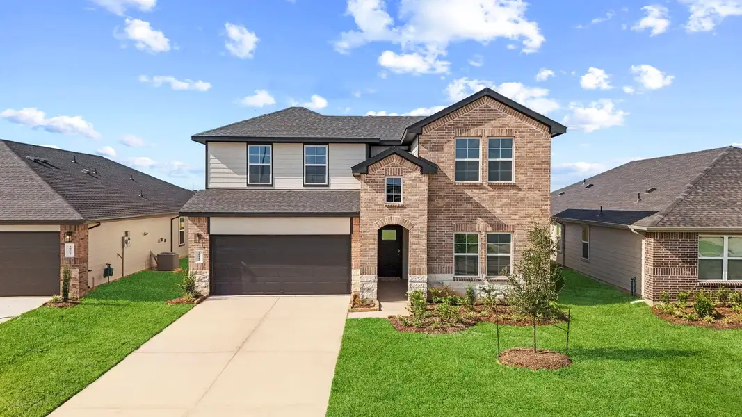 Front exterior of a new home in Tamarron, Fulshear, TX, highlighting curb appeal (Image 1). Front exterior of a new home in Tamarron, Fulshear, TX, highlighting curb appeal (Image 1).
