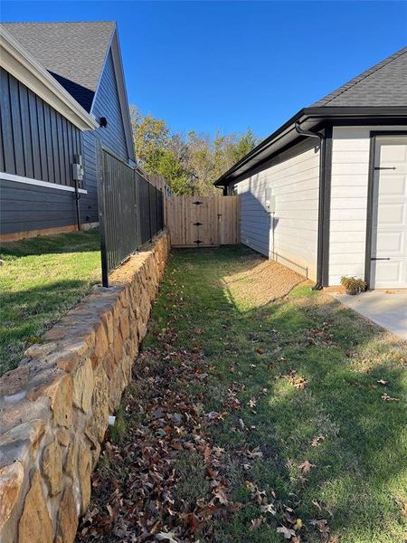 View of side of home with a yard