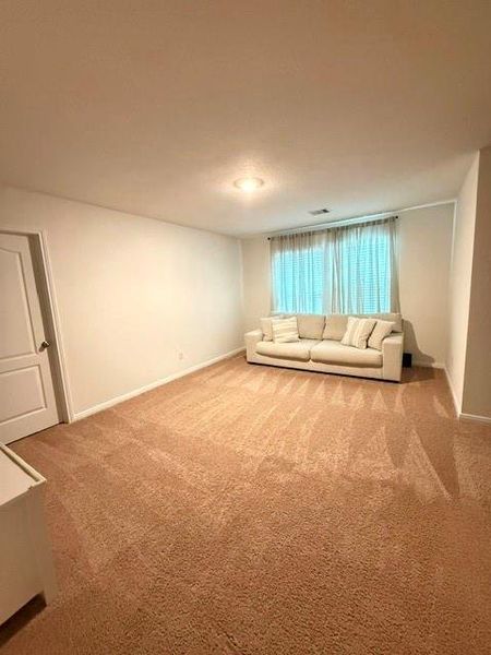 Flexible upstairs game room ideal for movie nights, play space, or a second living area. Flexible upstairs game room ideal for movie nights, play space, or a second living area.