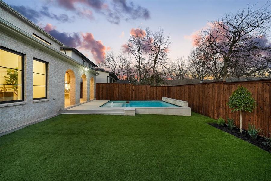 View of swimming pool featuring a fenced backyard and patio surround View of swimming pool featuring a fenced backyard and patio surround