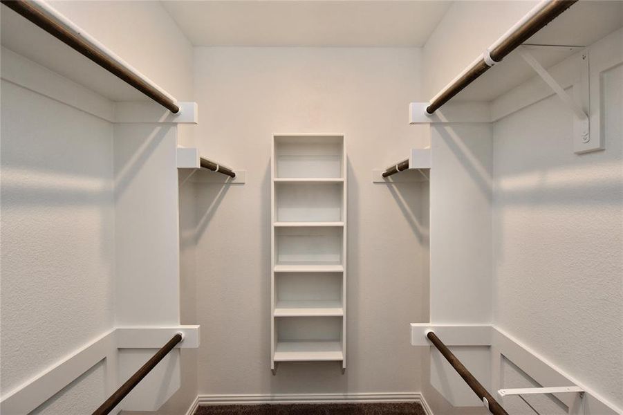 View of spacious closet in the primary bedroom