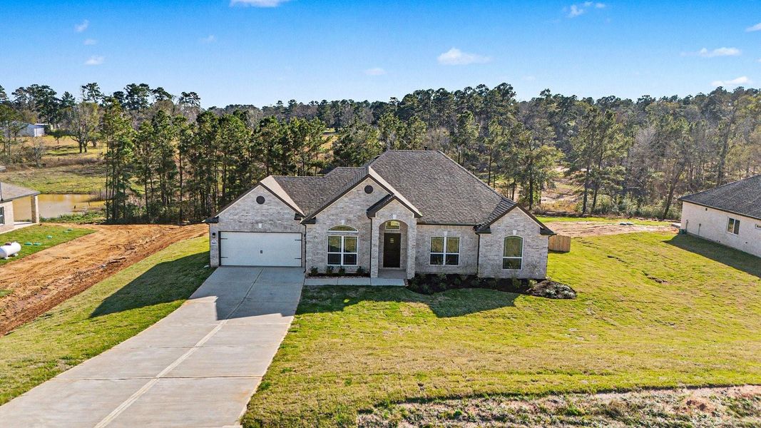 Front exterior of a new home in Rose Hill Estates, Willis, TX, highlighting curb appeal (Image 21).