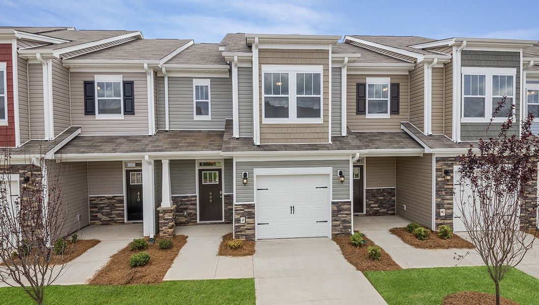Front exterior of a new home in Townes at Tap Root Farms, Fletcher, NC, highlighting curb appeal (Image 1). Front exterior of a new home in Townes at Tap Root Farms, Fletcher, NC, highlighting curb appeal (Image 1).