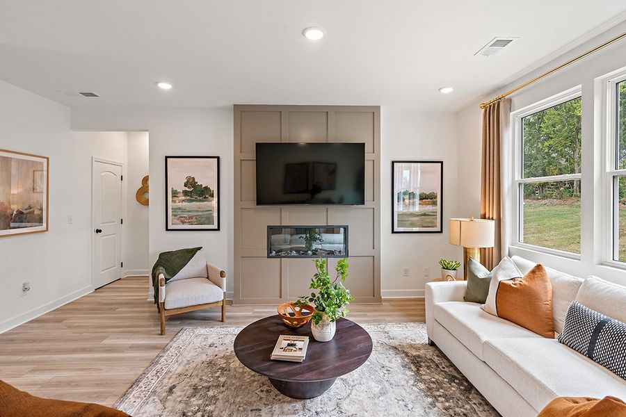 A living room with a large mirror. A living room with a large mirror.