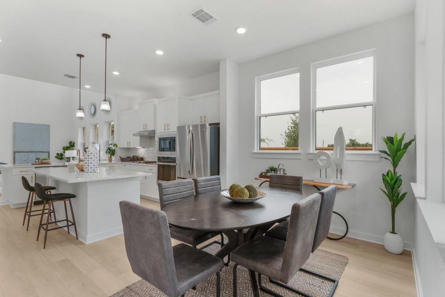 Dining room with light wood finished floors, recessed lighting, and baseboards Dining room with light wood finished floors, recessed lighting, and baseboards