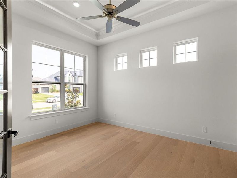 Empty room with light wood-type flooring, recessed lighting, crown molding, and ceiling fan Empty room with light wood-type flooring, recessed lighting, crown molding, and ceiling fan