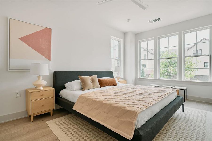 Bright bedroom with abundant natural light from multiple large windows