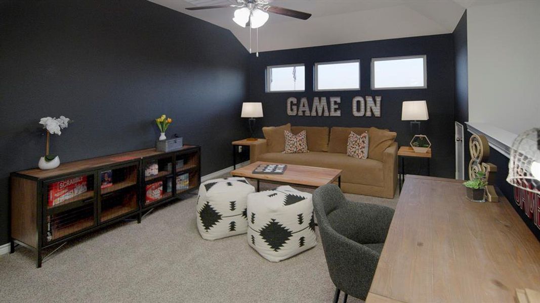 Carpeted room featuring a ceiling fan, dark accent wall, and three upper transom windows Carpeted room featuring a ceiling fan, dark accent wall, and three upper transom windows