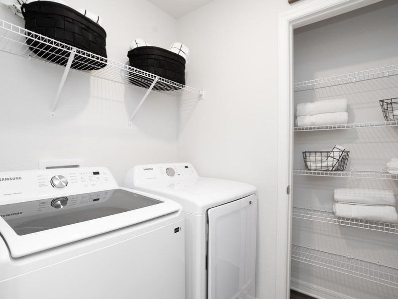 Upstairs dedicated laundry room with a storage closet- Aria home plan by Highland Homes