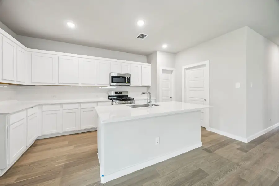Kitchen in the Hayden home plan by Trophy Signature Homes – REPRESENTATIVE PHOTO