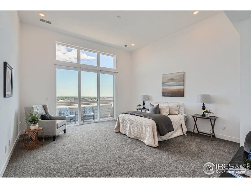 Primary suite with soaring views, access to private deck and 12' ceilings.