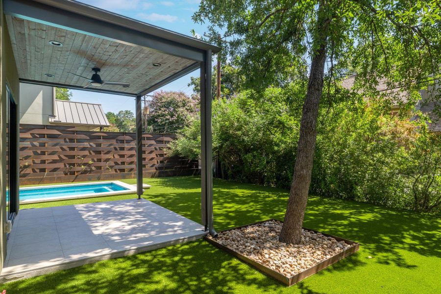 Covered patio featuring a wood-panel ceiling with a ceiling fan, recessed lighting, and a paved surface