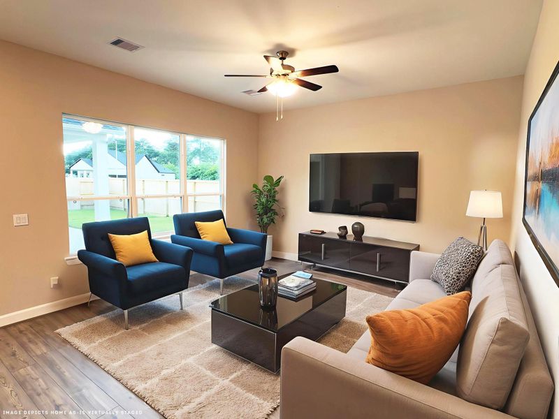 This living Space Features and expansive, light filled area with large windows and a versatile layout perfect for entertaining and everyday living. Image depicts home as-is virtually staged.