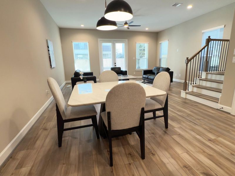 The ROCburne’s dining area blends seamlessly with the open floor plan, offering a bright, inviting space perfect for both intimate dinners and lively gatherings. Image depicts home as-is.