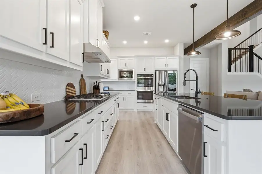 You'll Appreciate The 5-Burner Gas Cooktop, Double Ovens And Oversized Sink With Designer Faucet.
