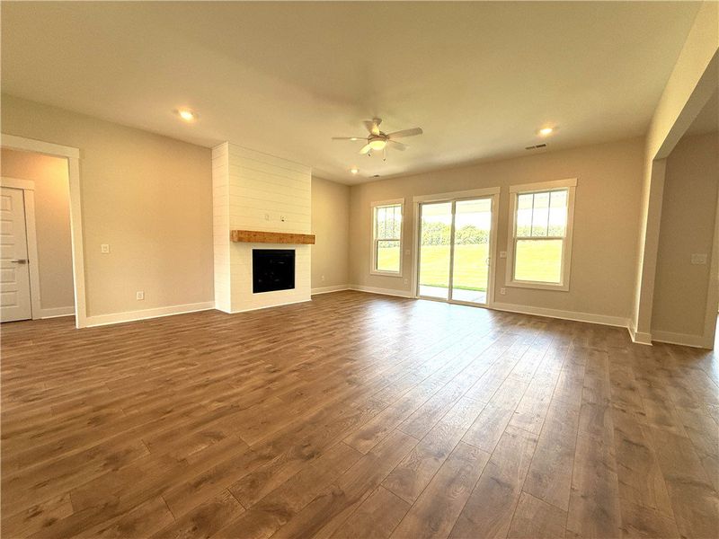 A spacious living area features a charming firepla A spacious living area features a charming firepla