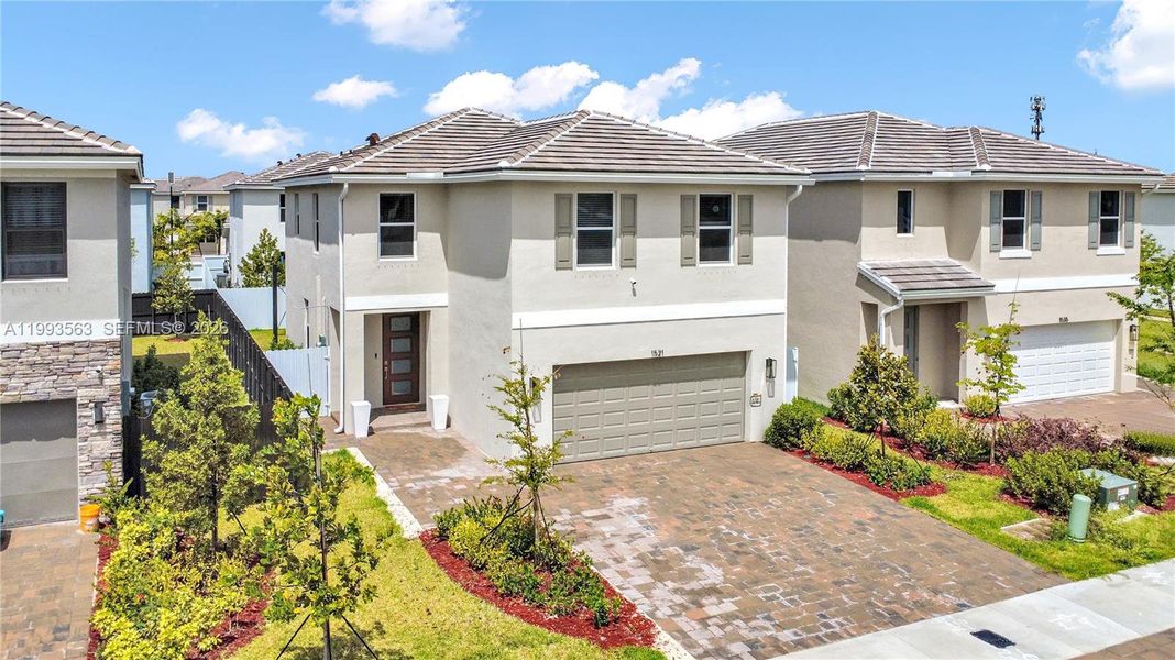 Front exterior of a new home in Messina Place, Homestead, FL, highlighting curb appeal (Image 28). Front exterior of a new home in Messina Place, Homestead, FL, highlighting curb appeal (Image 28).