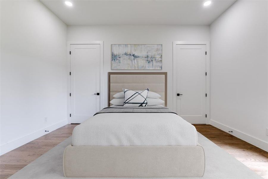 Bedroom with recessed lighting and wood finished floors