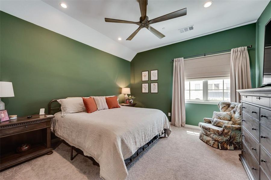 Bedroom featuring light colored carpet, lofted ceiling, ceiling fan, and recessed lighting