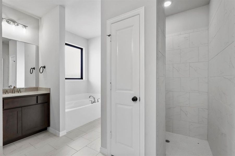 Bathroom with vanity, plus walk in shower, and tile patterned floors