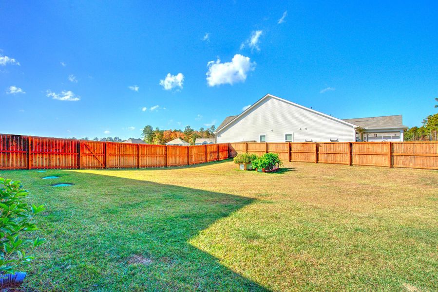 Exterior details and patio area of a home in French Quarter Creek, Huger (Image 31).