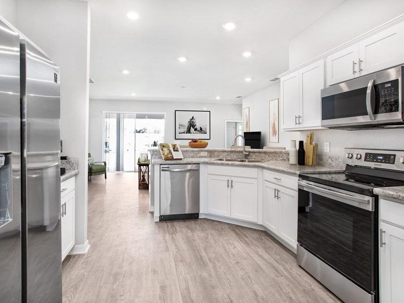 Open kitchen with walk-in pantry - Savannah home plan by Highland Homes