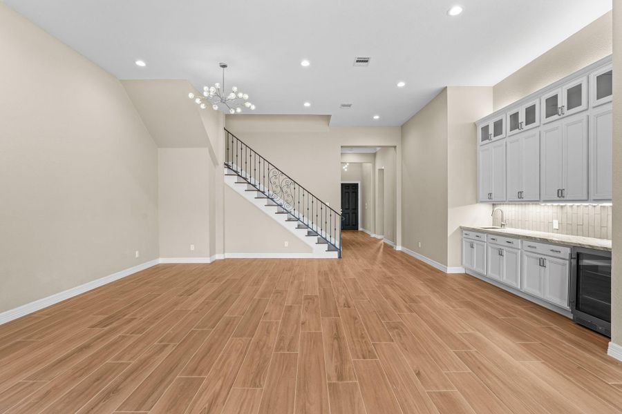 A striking view of the living area accented by the modern staircase and stylish finishes, combining comfort and design in one inviting space.
