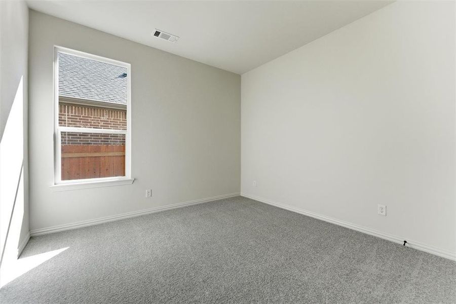 Empty room with carpet flooring and baseboards