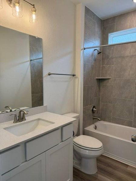Bathroom featuring a white vanity with a light-colored countertop, undermount sink, and brushed nickel faucet
