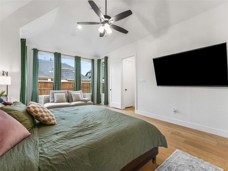 Another view of the primary bedroom with a wall of windows to the backyard.