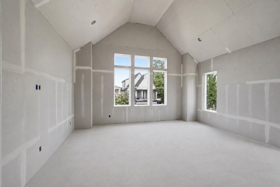 Primary bedroom features vaulted ceilings and abundant natural light. Primary bedroom features vaulted ceilings and abundant natural light.