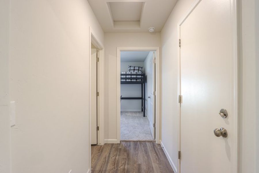 A hallway with white doors.