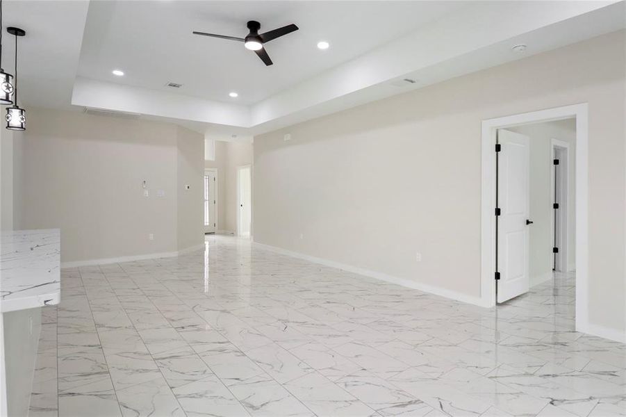 Living area with view of primary bedroom entrance.