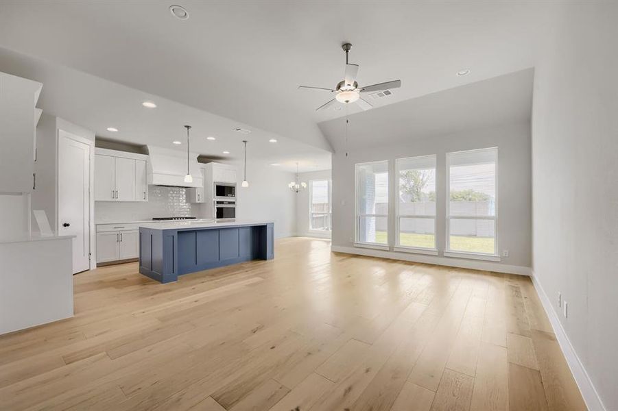 Open-concept living space with light wood-finish flooring