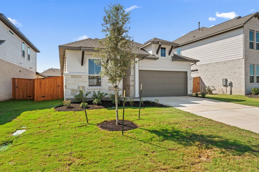 Front exterior of a new home in Lariat, Liberty Hill, TX, highlighting curb appeal (Image 2). Front exterior of a new home in Lariat, Liberty Hill, TX, highlighting curb appeal (Image 2).