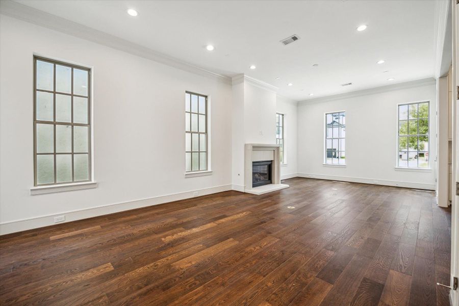 Living Room features cast stone fireplace and wonderful natural light from ample windows.