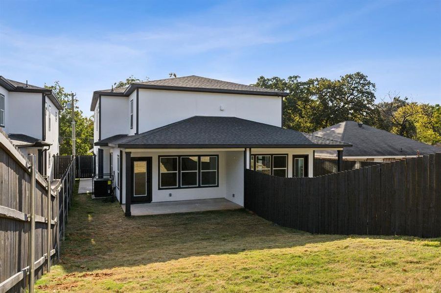 Rear view of property with a patio area, central AC, and a lawn