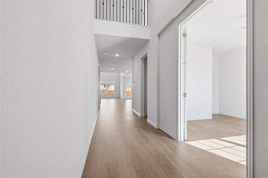 Corridor with light wood finished floors and recessed lighting Corridor with light wood finished floors and recessed lighting