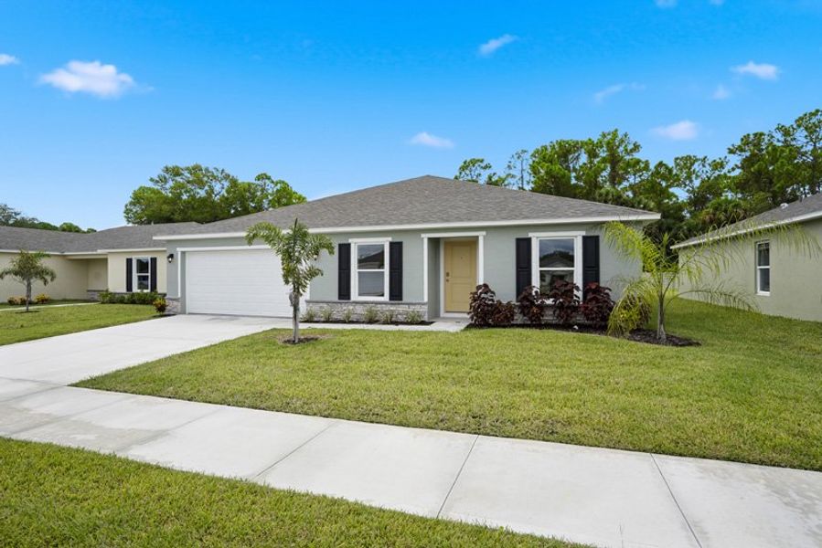 Front exterior of a new home in Richmond Cove, Palm Bay, FL, highlighting curb appeal (Image 2). Front exterior of a new home in Richmond Cove, Palm Bay, FL, highlighting curb appeal (Image 2).