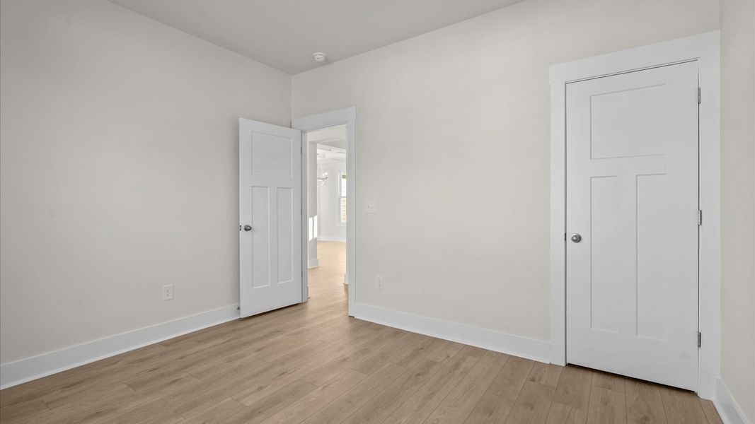 Desirable hardwood flooring in all bedrooms creates a cohesive and elegant interior