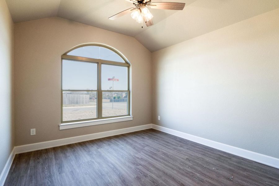Spare room with ceiling fan and dark wood-style flooring