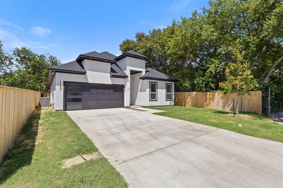 Prairie-style house featuring a shingled roof, stucco siding, an attached garage, and concrete driveway Prairie-style house featuring a shingled roof, stucco siding, an attached garage, and concrete driveway