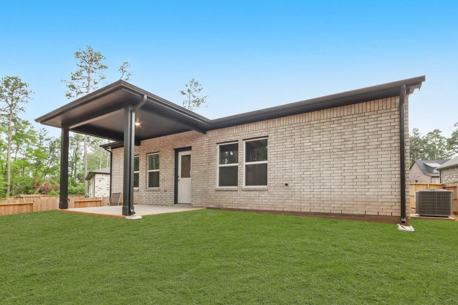 Front exterior of a new home in The Woodlands Hills, Willis, TX, highlighting curb appeal (Image 14). Front exterior of a new home in The Woodlands Hills, Willis, TX, highlighting curb appeal (Image 14).