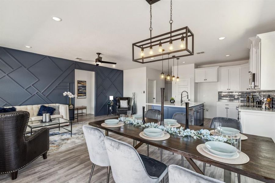 Dining room with light hardwood / wood-style floors and ceiling fan