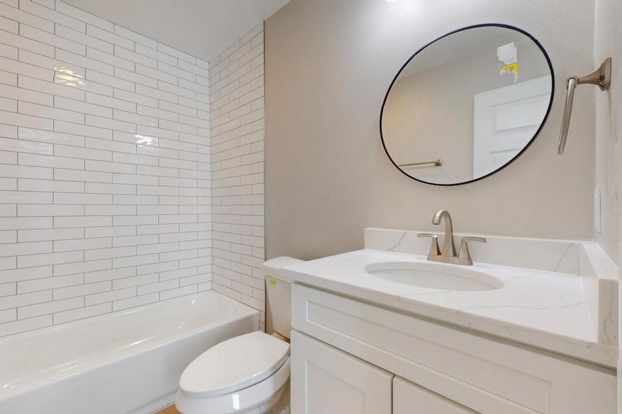 Whate subway tile to the ceiling, new tub, new fixtures. This house was rebuilt from the studs out.