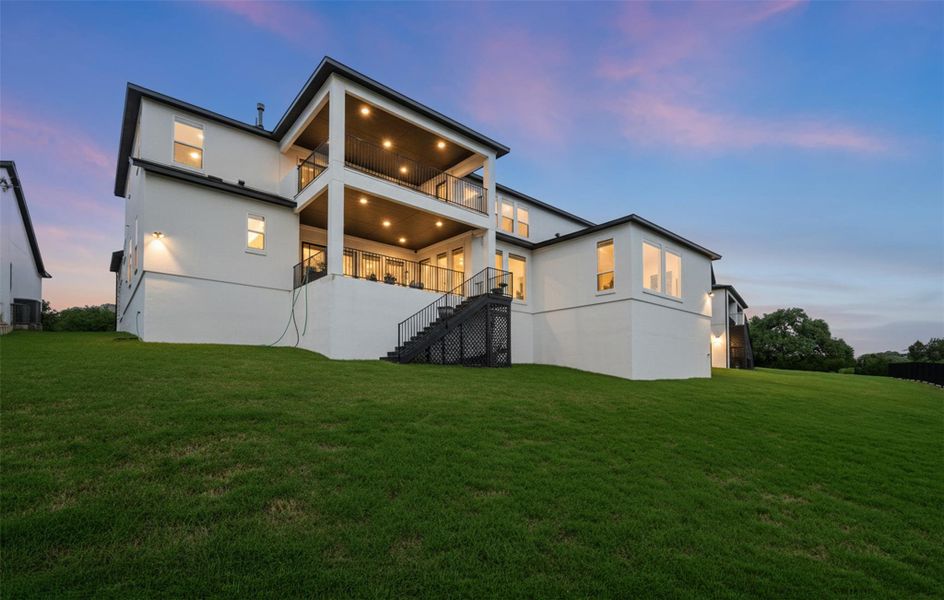 The property features a multi-level exterior with a large lawn