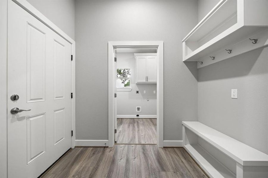 Walk in from the garage, sit down and take your shoes off! This 8.5 x 7.5 mud room is great for personal storage and a buffer into the laundry room.