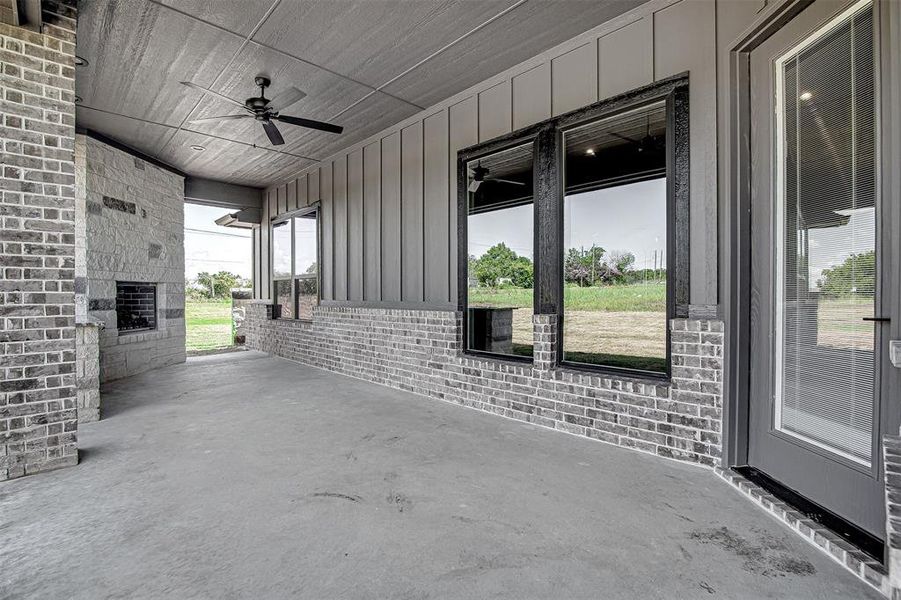 View of patio with ceiling fan and a porch