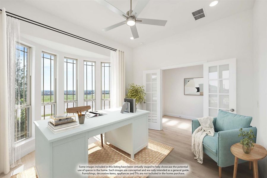 Home office with white desk, ceiling fan, large windows, and French doors with light wood floors